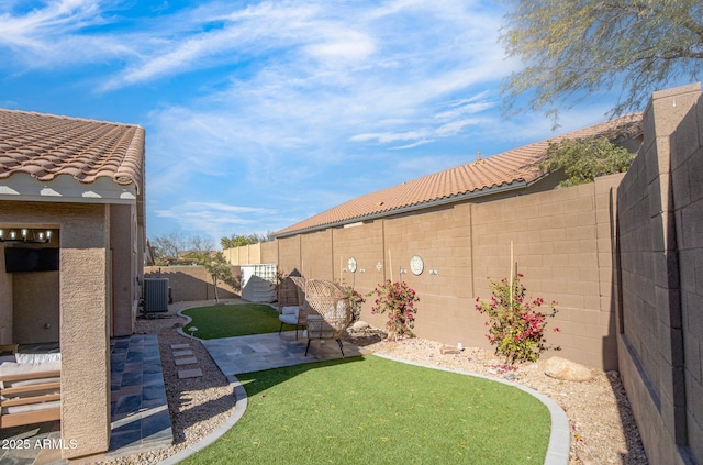 view of yard featuring central AC unit and a patio area