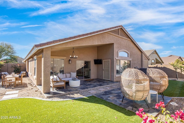 back of house featuring a patio and outdoor lounge area