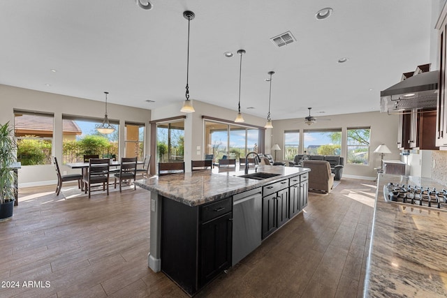 kitchen featuring light stone countertops, a wealth of natural light, ceiling fan, and stainless steel appliances