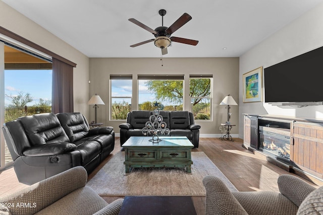 living room featuring light hardwood / wood-style flooring and ceiling fan