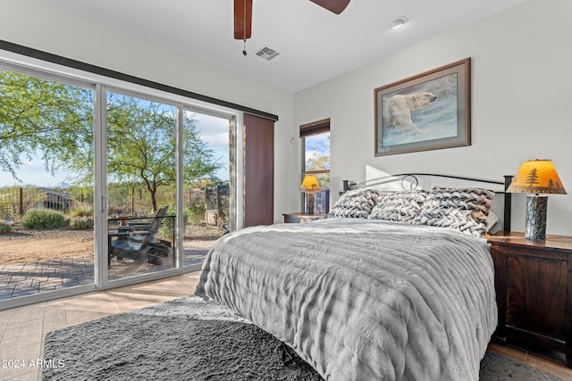 bedroom with access to outside, light hardwood / wood-style flooring, and ceiling fan