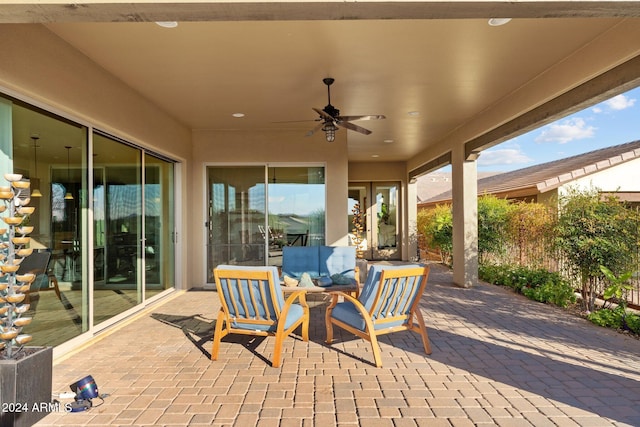 view of patio / terrace with ceiling fan and an outdoor living space