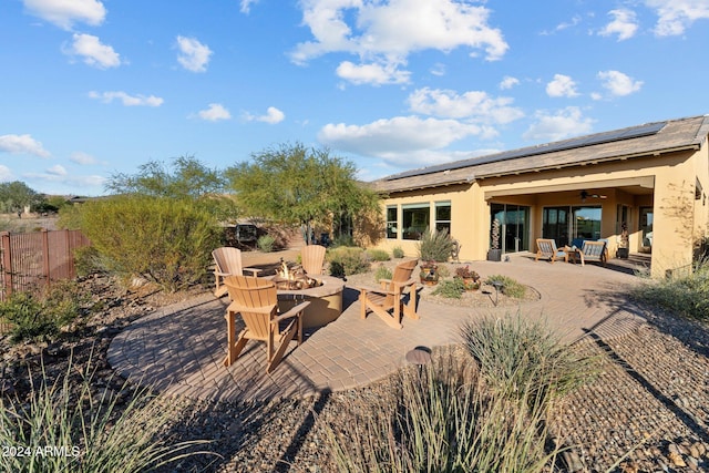 view of patio / terrace featuring an outdoor fire pit and ceiling fan