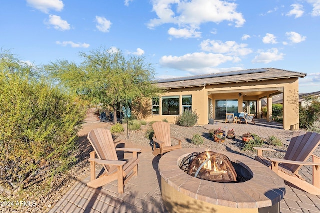 view of patio / terrace with an outdoor fire pit and ceiling fan