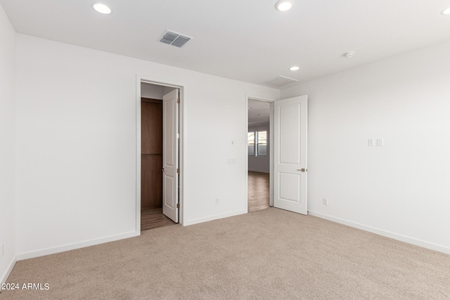 unfurnished bedroom featuring light colored carpet