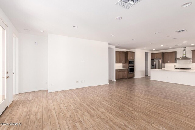 unfurnished living room with light wood-type flooring