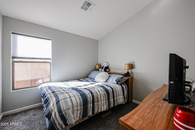 bedroom featuring lofted ceiling and dark carpet