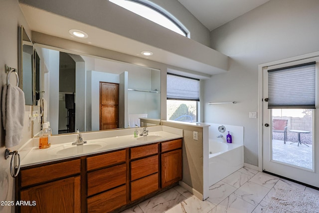 bathroom featuring vanity and a tub