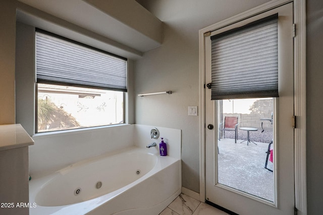 bathroom featuring a wealth of natural light and a washtub