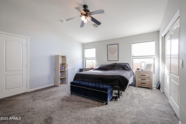 carpeted bedroom with ceiling fan, lofted ceiling, and a closet