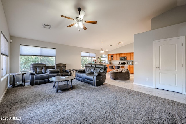 living room with vaulted ceiling and ceiling fan