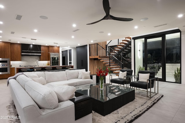 living room featuring ceiling fan and sink