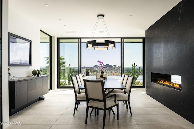 dining area featuring light tile patterned floors, expansive windows, and a multi sided fireplace