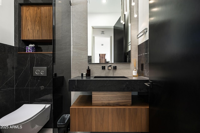 bathroom featuring tile walls, vanity, decorative backsplash, and toilet