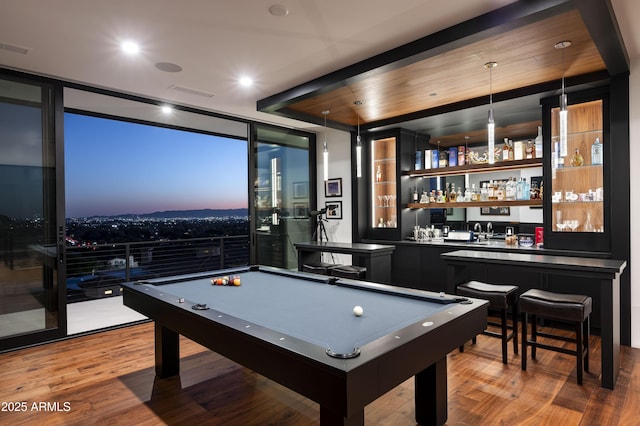 recreation room with bar, hardwood / wood-style floors, pool table, and a wall of windows