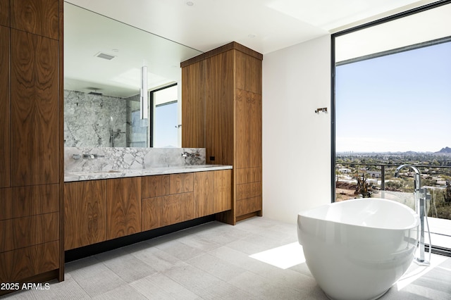 bathroom featuring floor to ceiling windows, independent shower and bath, and vanity