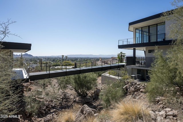 view of yard featuring a balcony and a mountain view