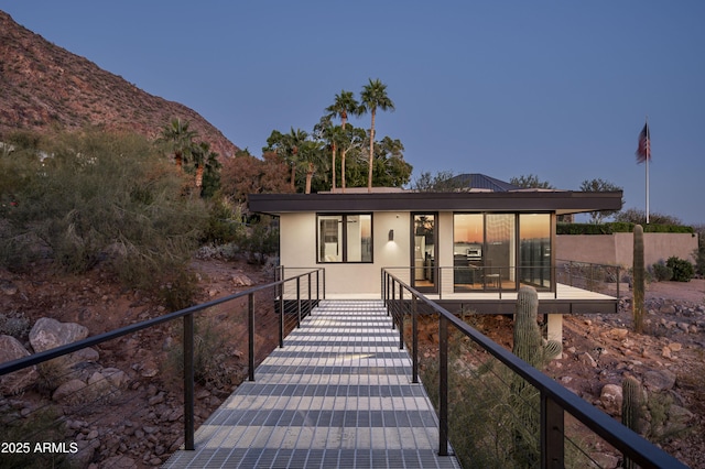 back house at dusk with a mountain view