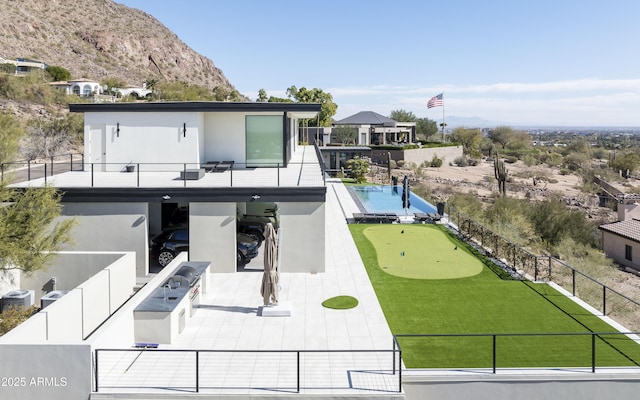 view of property's community featuring a pool, a mountain view, area for grilling, and a patio area