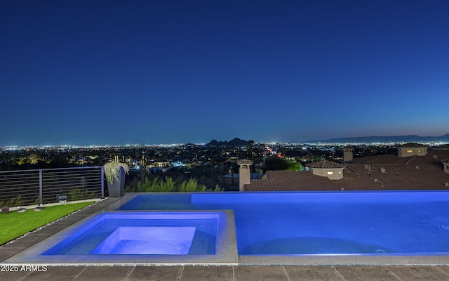 view of pool at dusk