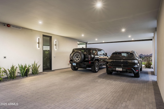 view of garage at dusk