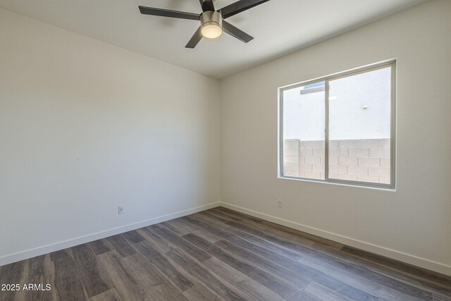 5096 S 245th Dr, Buckeye, AZ 85326 - spare room featuring dark wood-type flooring, a ceiling fan, and baseboards