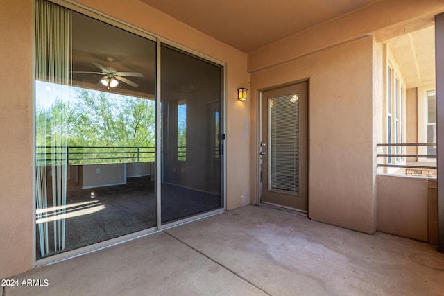 doorway to property with a balcony and ceiling fan