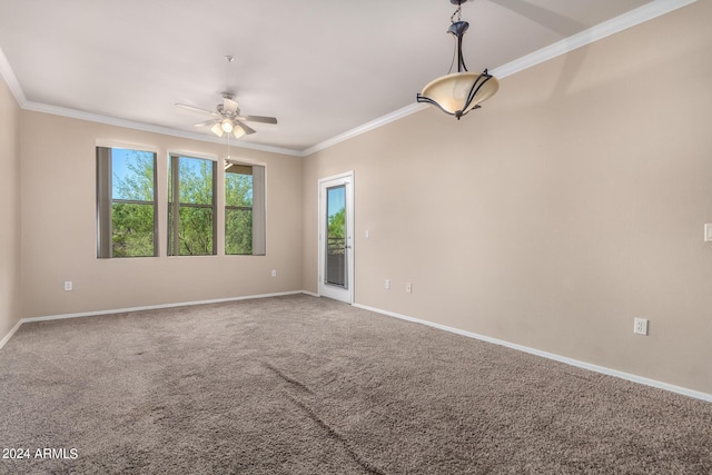 carpeted empty room with ceiling fan and crown molding