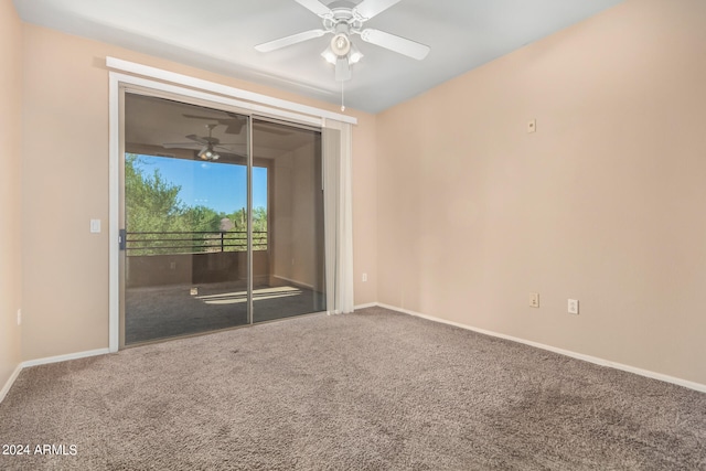 carpeted spare room featuring ceiling fan