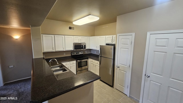 kitchen with white cabinetry, sink, kitchen peninsula, and stainless steel appliances