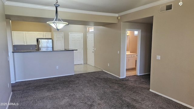 kitchen featuring pendant lighting, white cabinets, carpet floors, stainless steel refrigerator, and crown molding