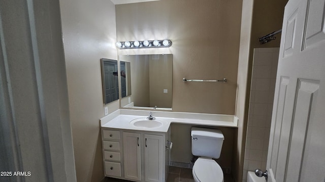 bathroom featuring toilet, vanity, and tile patterned floors