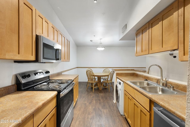 1185 W University Ave Unit 213, Flagstaff, AZ 86001 - kitchen with appliances with stainless steel finishes, washer / clothes dryer, dark wood finished floors, and light countertops