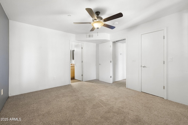 1185 W University Ave Unit 213, Flagstaff, AZ 86001 - unfurnished bedroom featuring light carpet, ensuite bathroom, and ceiling fan