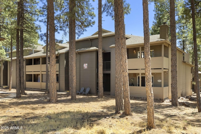 1185 W University Ave Unit 213, Flagstaff, AZ 86001 - back of property with a chimney and a shingled roof