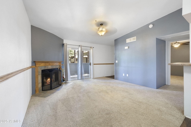 1185 W University Ave Unit 213, Flagstaff, AZ 86001 - unfurnished living room with a tile fireplace, ceiling fan, and carpet flooring