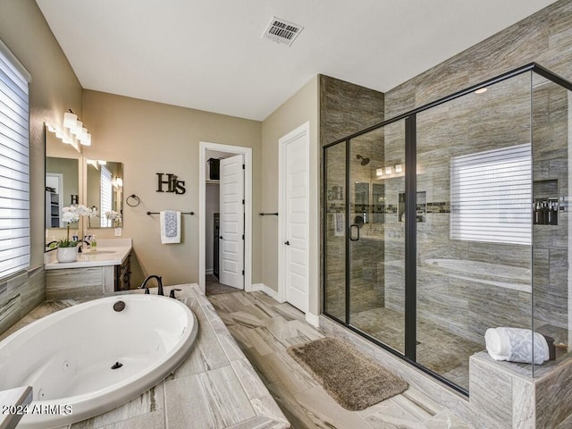 bathroom with vanity and independent shower and bath