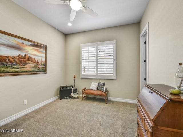 sitting room with light colored carpet and ceiling fan