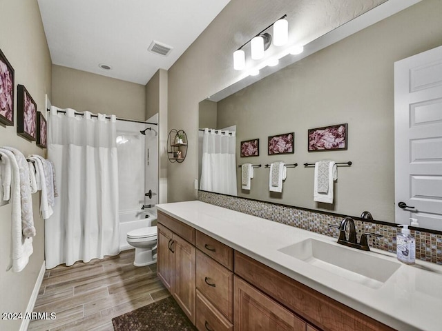 full bathroom with vanity, hardwood / wood-style flooring, shower / bath combination with curtain, and toilet