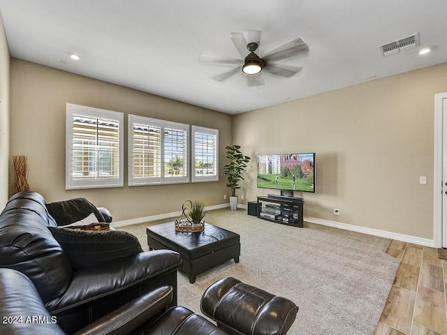 living room featuring light wood-type flooring and ceiling fan