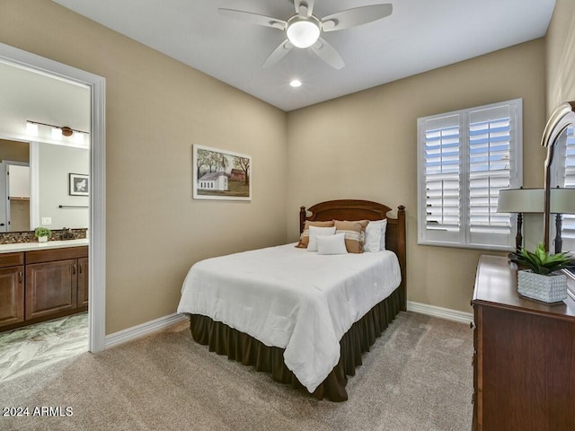 carpeted bedroom featuring ensuite bathroom and ceiling fan