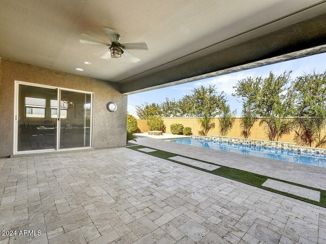 view of patio / terrace with a fenced in pool and ceiling fan