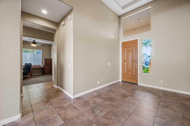 foyer entrance with tile patterned floors and ceiling fan