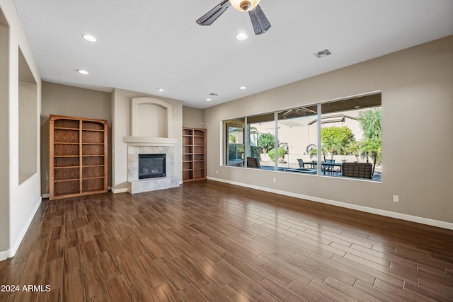 unfurnished living room featuring ceiling fan, a fireplace, and hardwood / wood-style flooring