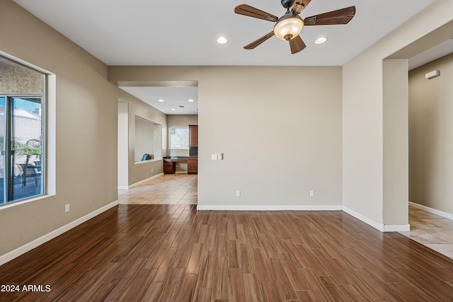 spare room featuring hardwood / wood-style flooring and ceiling fan