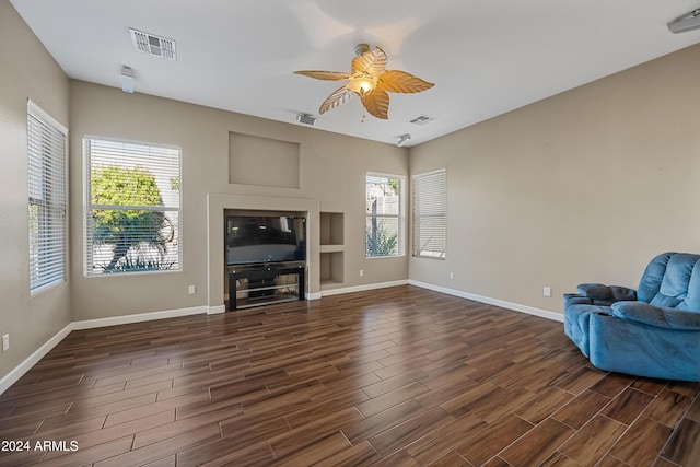 unfurnished living room with ceiling fan