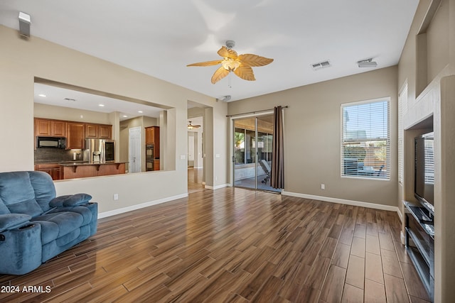 living room with ceiling fan and a healthy amount of sunlight