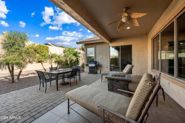 view of patio with a grill, ceiling fan, and a fire pit