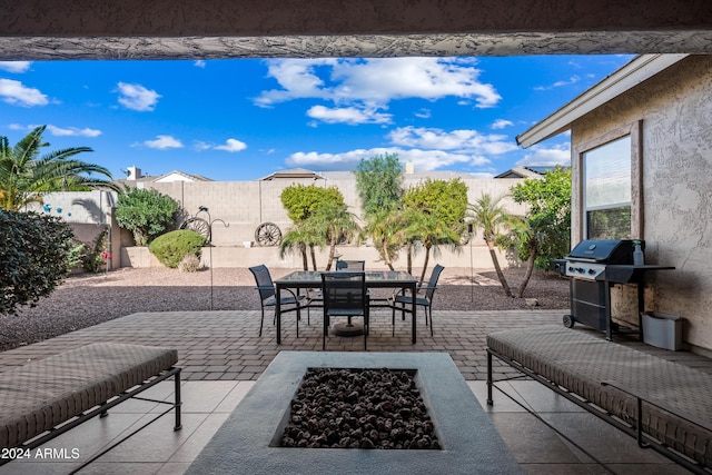 view of patio featuring a fire pit and a grill