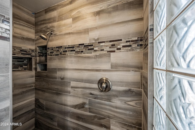 bathroom with a tile shower